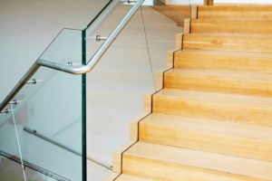 Wooden staircase with glass rail