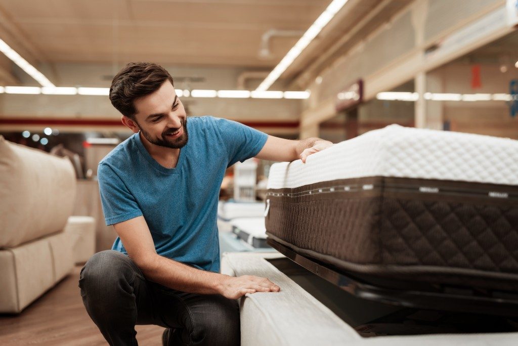 a man shopping for a mattress