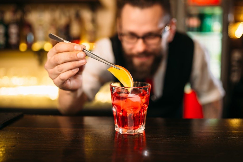 Bartender making alcohol coctail in restaurant