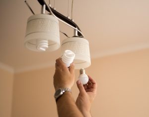 Man changing an electric bulb