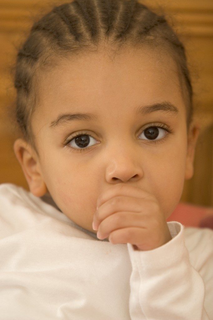 girl sucking her thumb