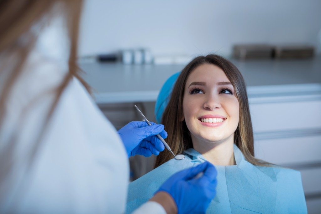 a woman having a dental check up with her dentist