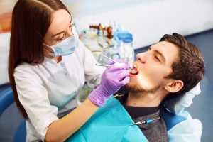 Man at the dentist during a dental procedure