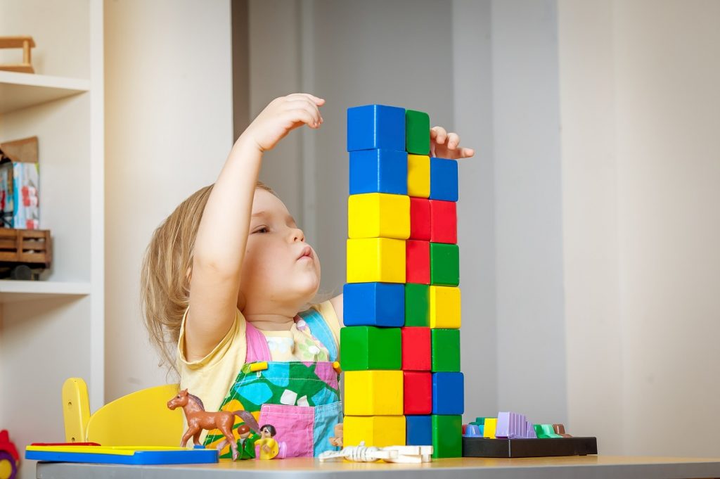 toddler playing block toys