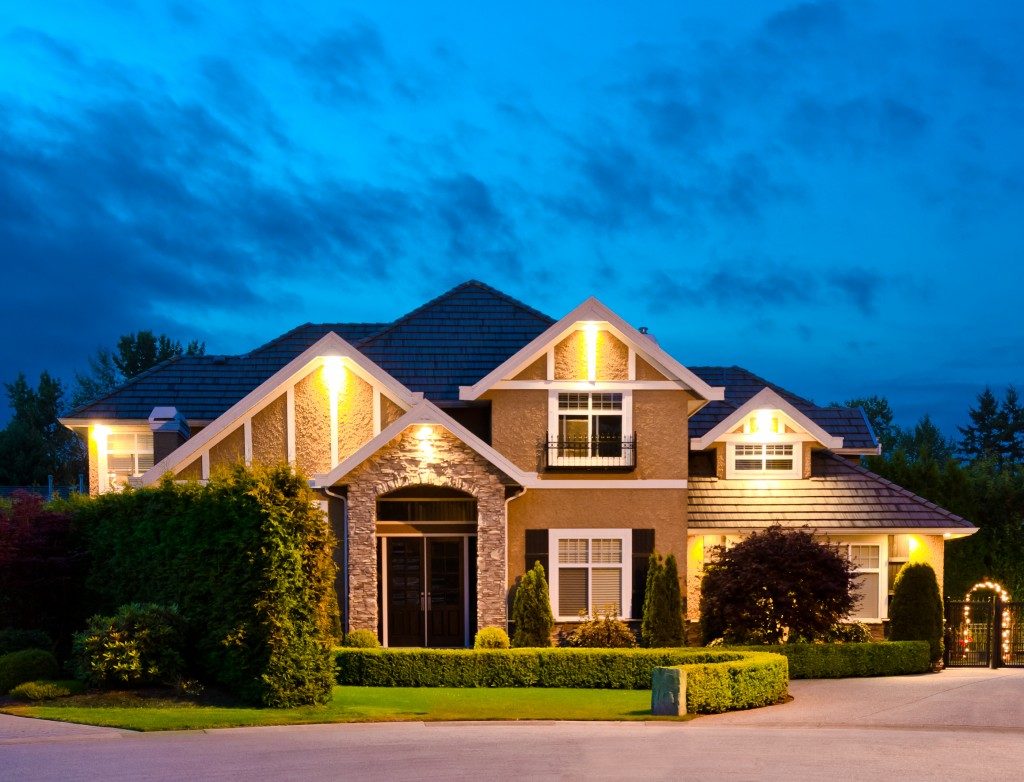 Big luxury house at dusk, night in suburbs