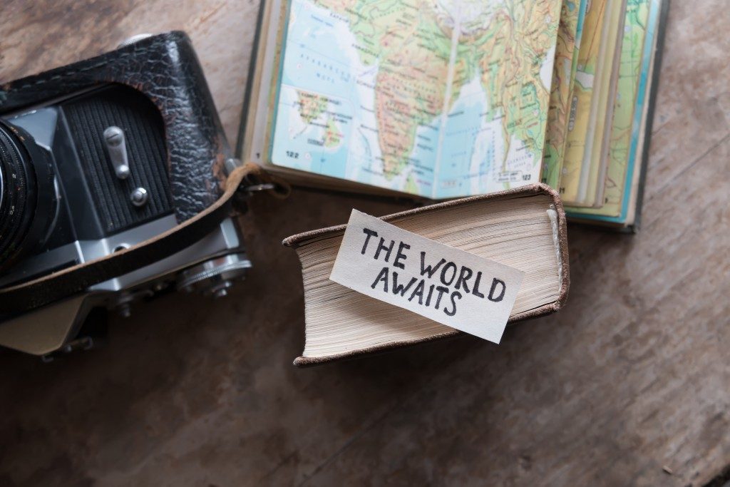 Travel concept with vintage camera and map