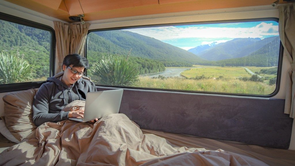 man working inside a camping van