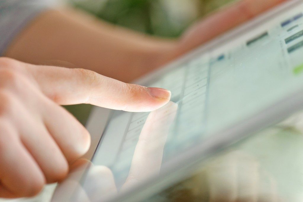 person answering a survey on her tablet