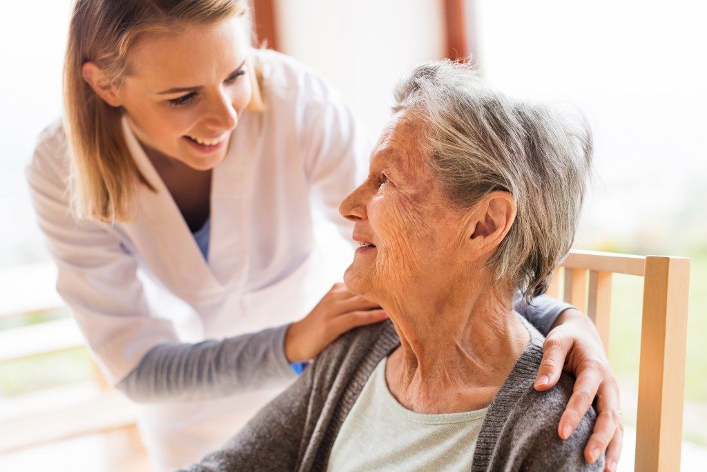 nurse taking care of an elder woman
