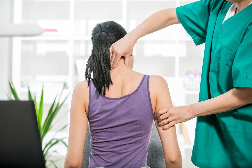 Doctor doing neck adjustment in medical office
