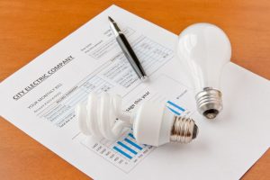 electric bill and lightbulbs