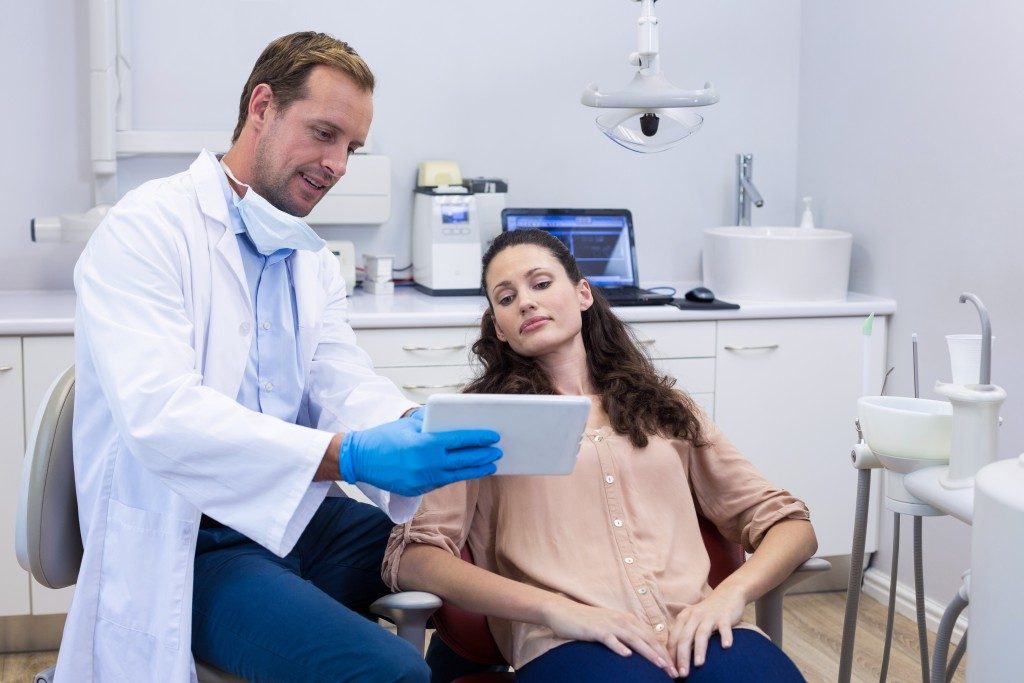 dentist explaining something to his patient